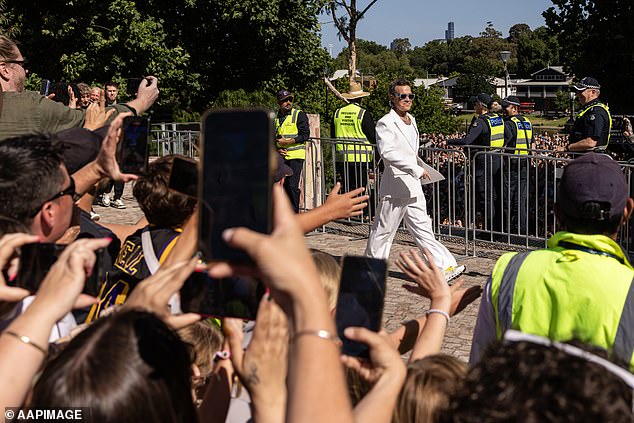 Robbie arrived at Fed Square and was surrounded by a horde of screaming fans