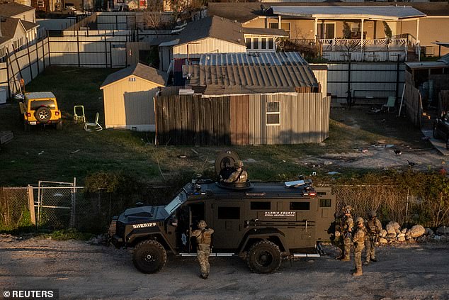 A drone shot shows Federal Bureau of Investigation (FBI) and Harris County law enforcement officers surrounding a home in an armored vehicle in north Houston, Texas, U.S., January 1, 2025