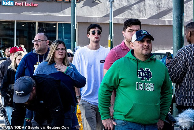 Notre Dame Fighting Irish fans walk past the scene in the French Quarter where 15 people were killed