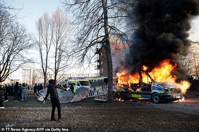 Police vans are on fire during clashes between protesters and police in 2022