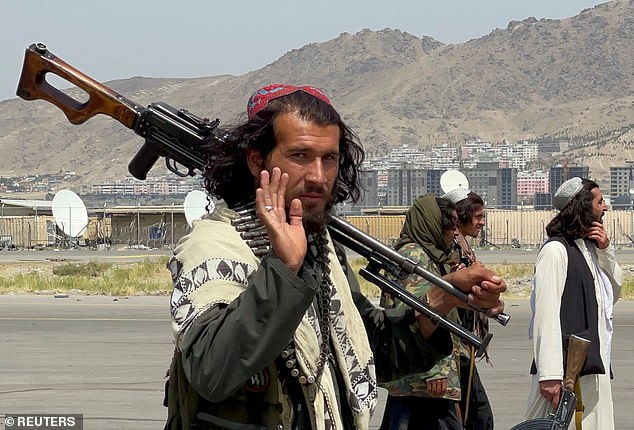 Armed Taliban patrol the airport runway, a day after the last US troops left