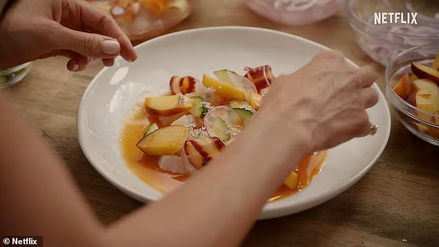 Meghan prepares a light, summery dish that appears to incorporate peaches, thinly sliced ​​radishes and cucumber with a dressing