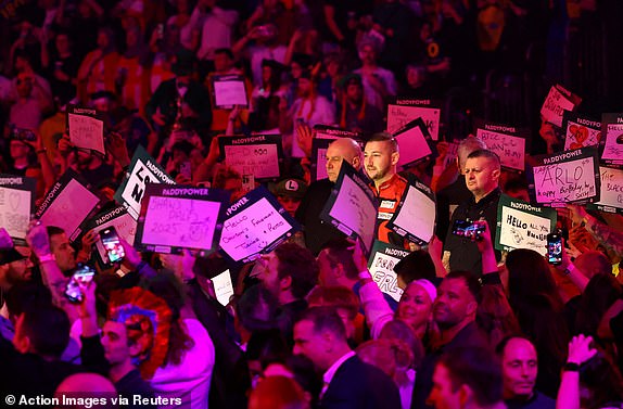 Darts - PDC World Darts Championship 2025 - Alexandra Palace, London, Great Britain - January 1, 2025 Nathan Aspinall during his walk before his quarter-final against Luke Littler Action Images via Reuters/Andrew Boyers