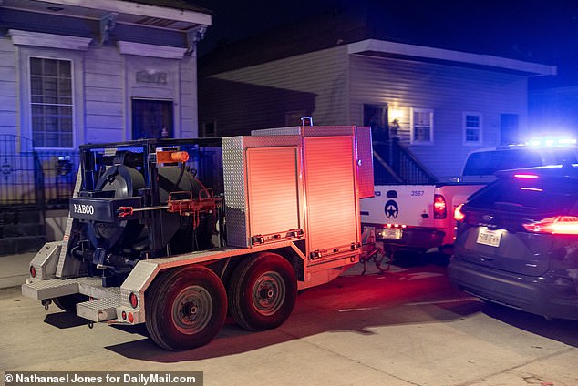 New Orleans police remove a bomb containment vessel from the building