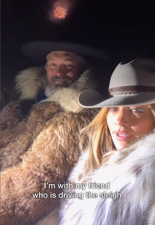 She sat next to a handsome 'friend' for a sled ride in the snow