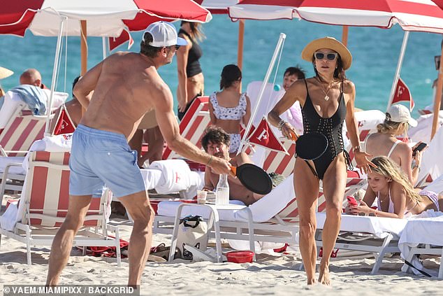 Her boyfriend – the founder of Yapstone – opted to go shirtless and wore light blue swim trunks