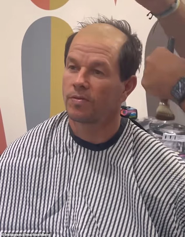 In the clip, Wahlberg sits in a barber's chair as his stylist shaves off parts of his signature dark brown hair, leaving the front and crown completely exposed – a striking look for his latest role