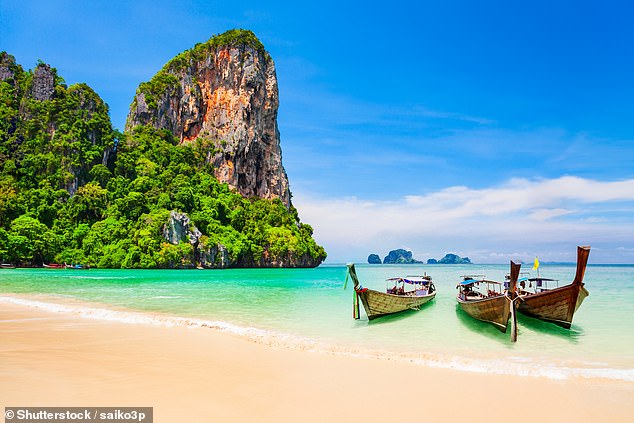 Boats on the beauty beach with limestone cliff and crystal clear water in Koh Samui