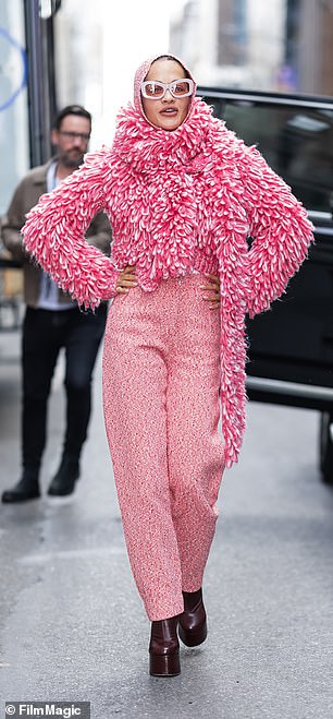 For her second look, the beauty made a statement by wearing pink tweed pants and a pink and white colored sweater.