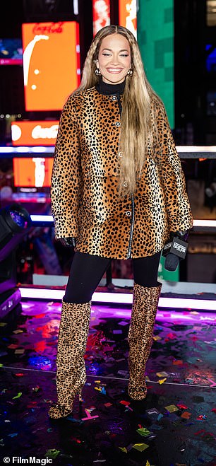 In another look, she wore a leopard print jacket and matching knee-high boots