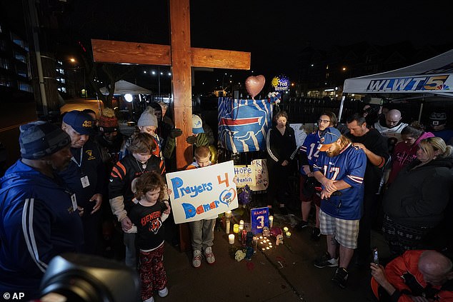 People pray during a prayer vigil for Hamlin outside the University of Cincinnati Medical Center