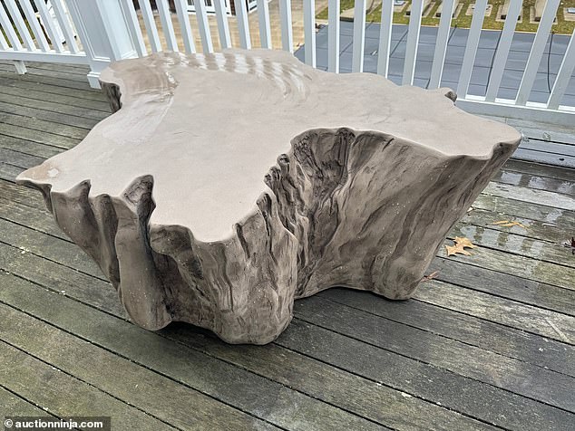 A bizarre faux teak outdoor table has a high bid of $130.