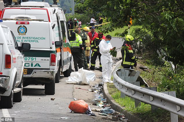 The vehicle was carrying 42 passengers and the victims were rushed to hospitals in Tangua, Ipiales and the city of Pasto, as reported by NTN24. In the photo: Police and rescue workers inspect the crash site