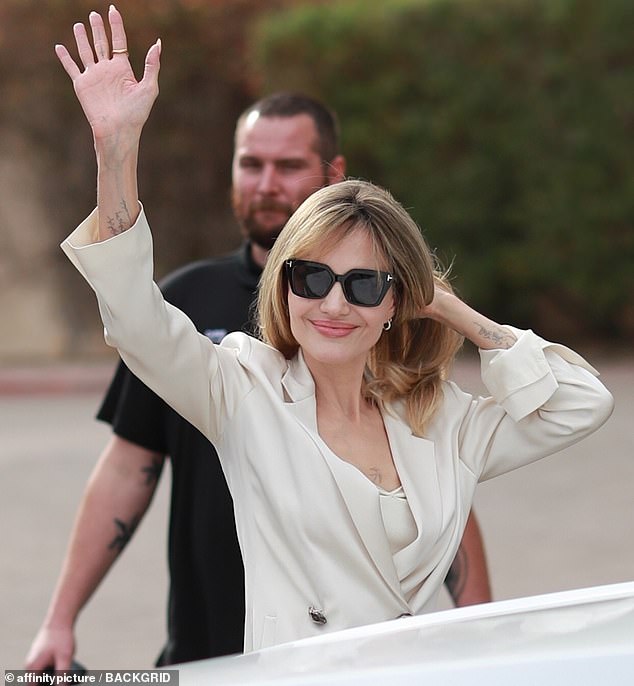 Jolie paused for a quick photo session on the red carpet and also waved friendly to fans waiting outside the venue