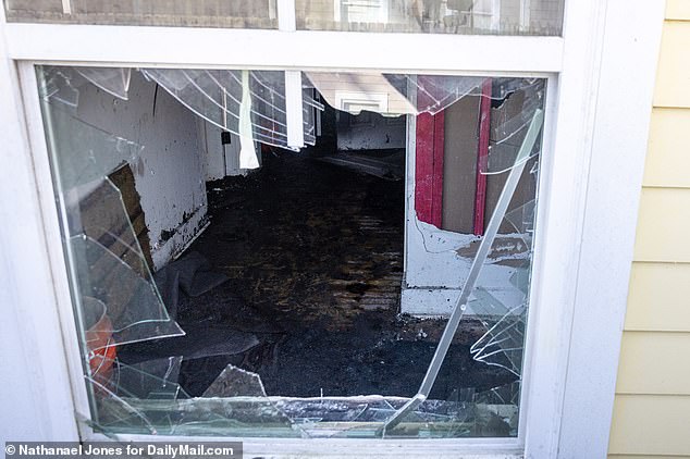 A smashed window offered a glimpse into a room that appeared to be on fire