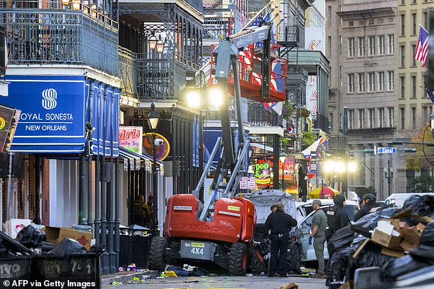 Police investigators surround a white truck that crashed into a work elevator in New Orleans' French Quarter