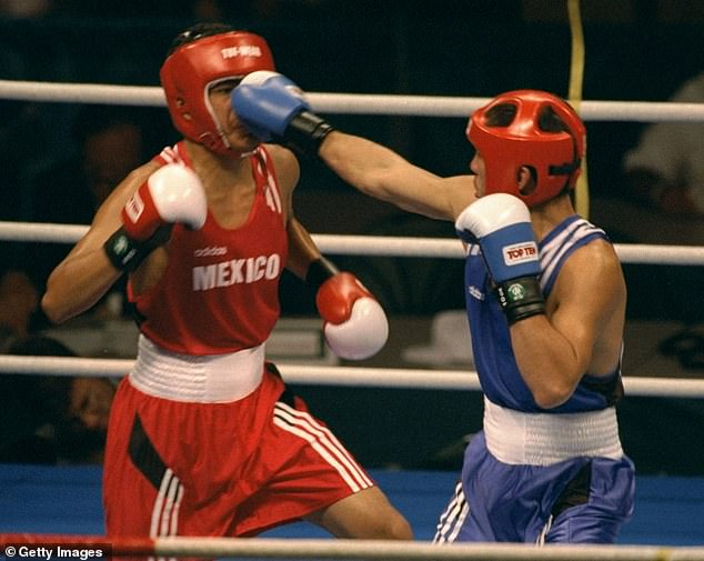 Traditionally associated with passion, aggression and dominance, this color gave participants an edge in contact sports, according to the 2005 study. Pictured: Boxing at the 1996 Olympics