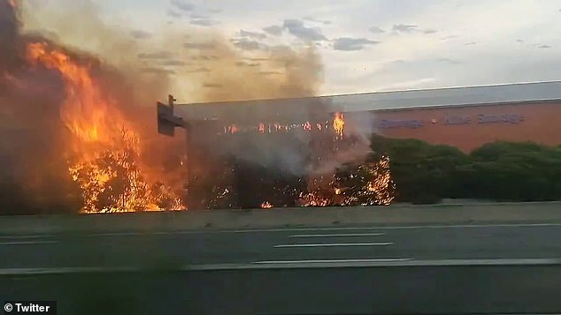 Footage shared on social media shows out-of-control flames tearing through the storage facility, while nearby trees are engulfed and a huge plume of black smoke hangs over the city