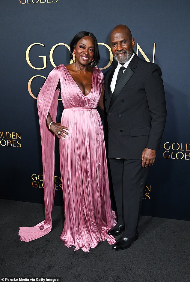 Viola was also joined on the carpet by her husband Julius Tennon, 71, who looked incredibly dapper in a black double-breasted blazer with satin lapels and tailored trousers.