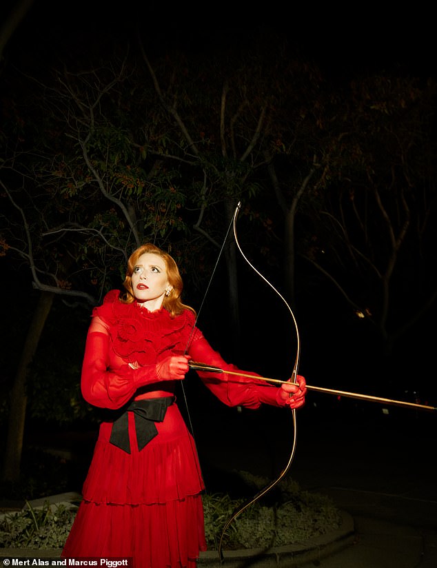 Natasha Lyonne wore a red ruffled dress as she posed with a bow and arrow