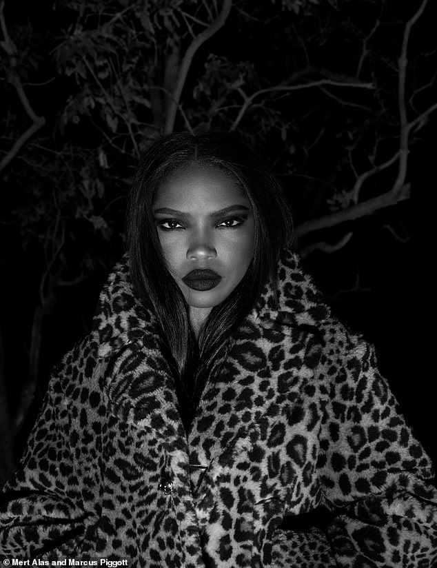 Ryan Destiny posed in a leopard print jacket and bold red lipstick