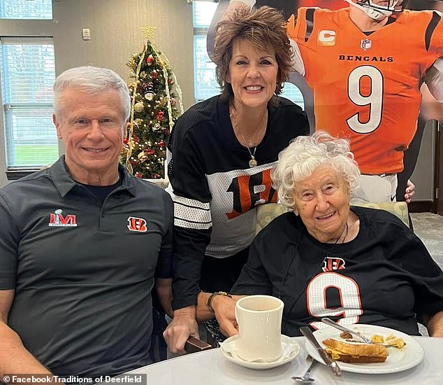 Flo watches the football match with her son Rick and daughter-in-law