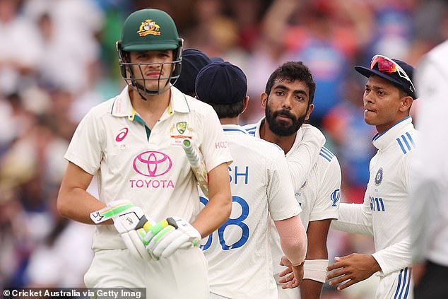 The Indian team surrounded the youngster after he claimed the wicket of Usman Khawaja to end the opening day of the Test