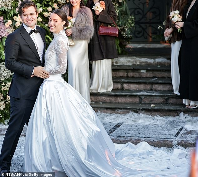 The world's number one chess player and his new bride (both pictured) beamed as they posed for photos