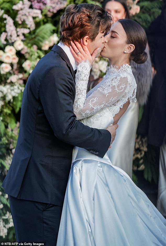 SEALED WITH A KISS: The newlyweds were not shy and showed their affection for each other with a passionate hug outside the chapel