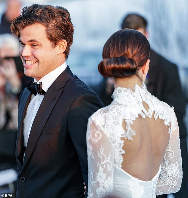 Beaming: Chess grandmaster Magnus Carlsen was seen beaming as he stood next to his new wife