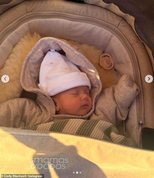 Baby Eva June was put to sleep in her buggy while wrapped in her coat and a cute hat