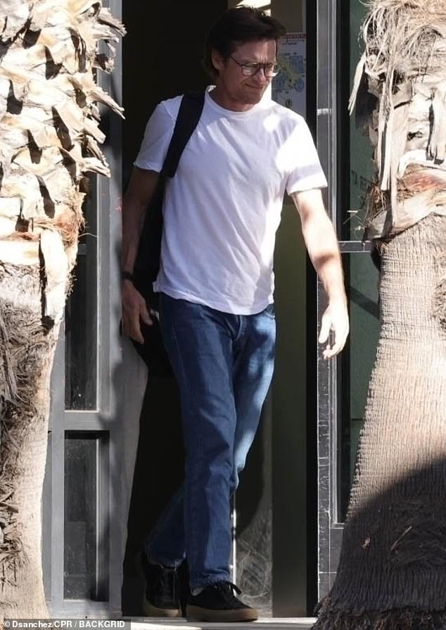 Meanwhile, Jason cut a casual figure in a white T-shirt and dark jeans, slinging a backpack over one shoulder and accessorizing with a watch.