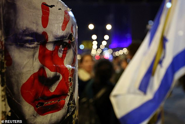 A protester taped an anti-Netanyahu poster to a lamppost in Tel Aviv this evening