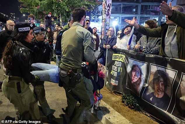 Protesters argue for police arresting an apparently peaceful protester