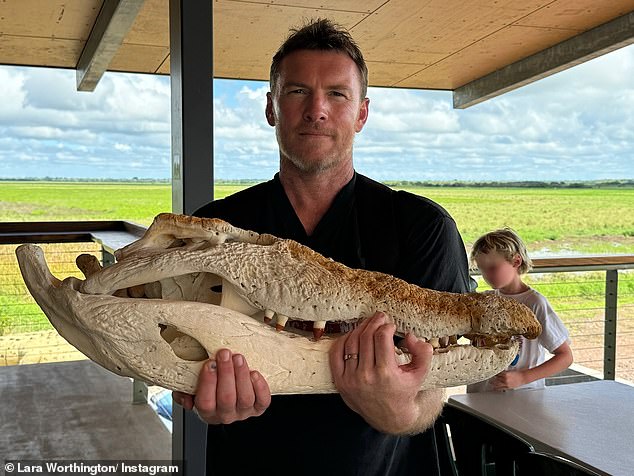 In one image, Sam, 48, (pictured) held up a skull of what appeared to be a crocodile, while one of their sons played in the background