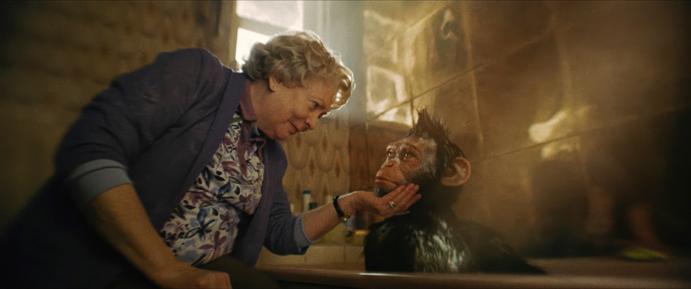 In Better Man, Alison Steadman holds the chin of a CG monkey Robbie Williams taking a bath as they look into each other's eyes