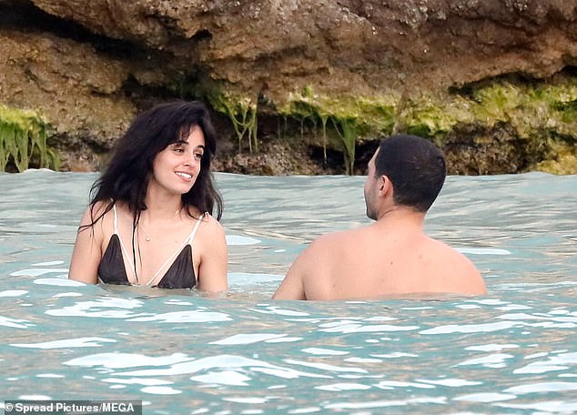 She left her long, chocolate brown locks in perfect beach waves and ditched makeup to show off her natural, radiant beauty.