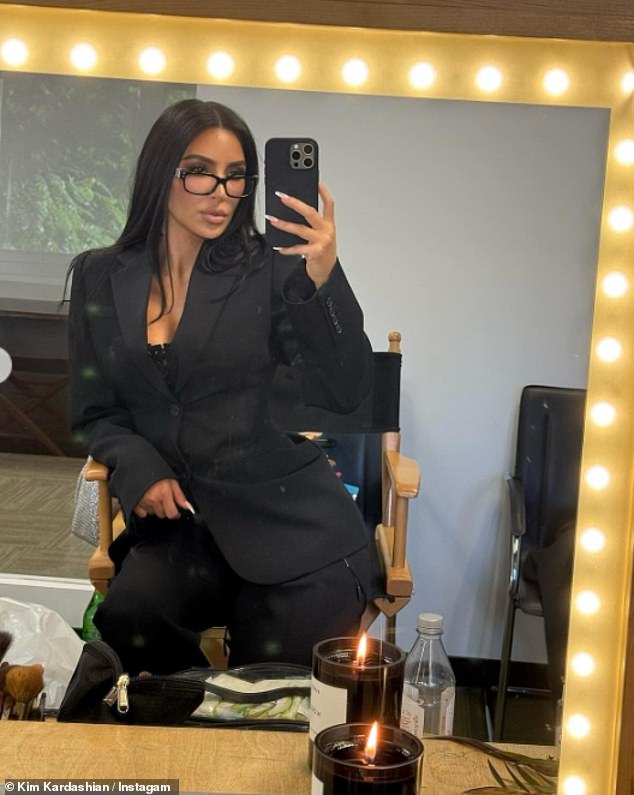 Delivering a more sophisticated look, the TV personality stunned in a smart black blazer, matching trousers and wore reading glasses as she posed for a mirror selfie