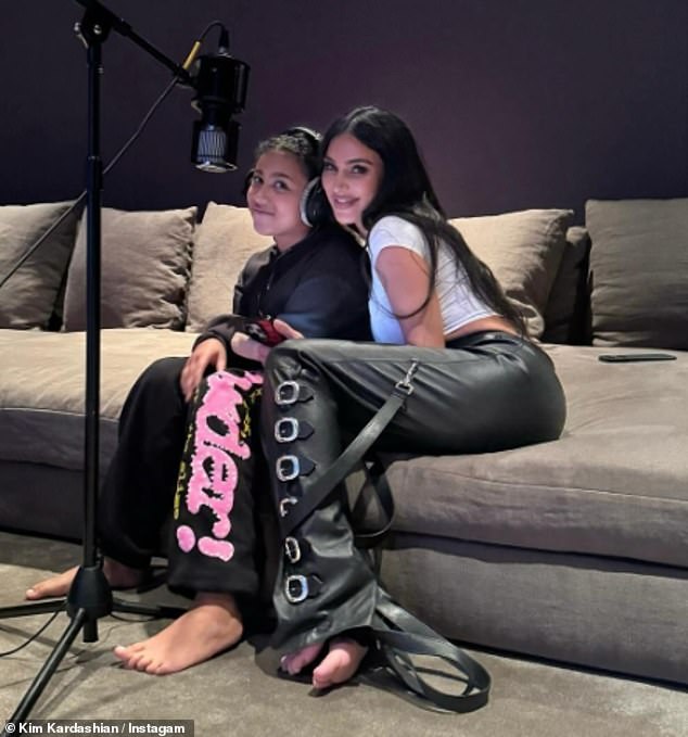 Kim couldn't contain her smile as she snuggled up to eldest daughter North while recording voiceovers while sitting on a large couch