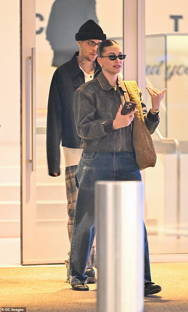 Hailey cut a casual figure in dark jeans, a brown leather bomber jacket and black suede loafers