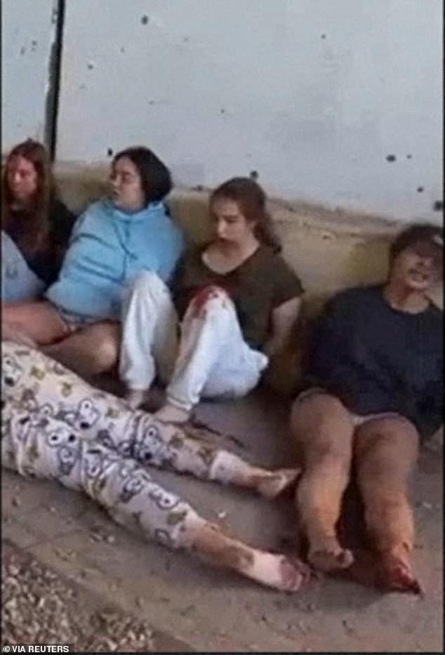 Pictured alongside other hostages, the group of young Israeli women appeared to have been injured by their captors