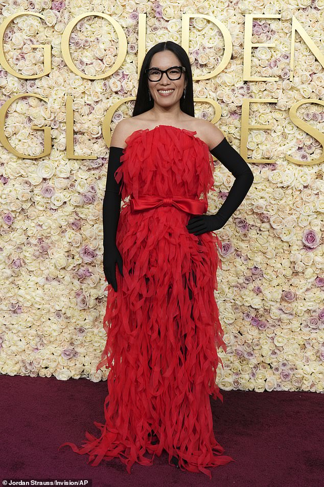 Comedian Ali Wong went overboard with a strapless red dress with fringe details and long black gloves