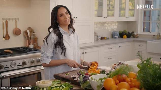 In a post previewing her new Netflix show With Love, Meghan is filmed in a beautiful kitchen as she prepares a meal for smiling guests