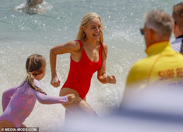 Carrie enjoyed the summer holidays and frolicked around in the shallow water with her two daughters, Evie, nine, and Adelaide, six.