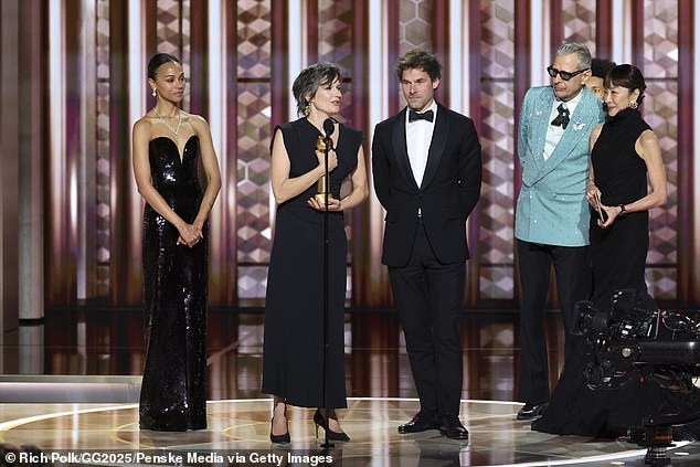 Saldaña took the stage for the second time to support composers Camille (2-L) and Clément Ducol (3-L) as they accepted the trophy, telling her, “Zoe, you just shook the house and our souls shaken'