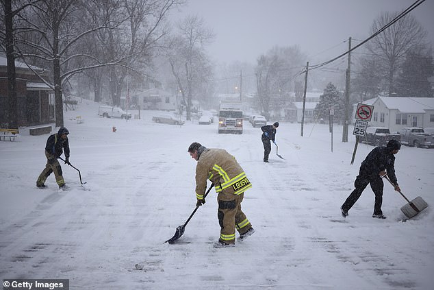 Firefighters from Louisville, Kentucky are shoveling snow-covered streets