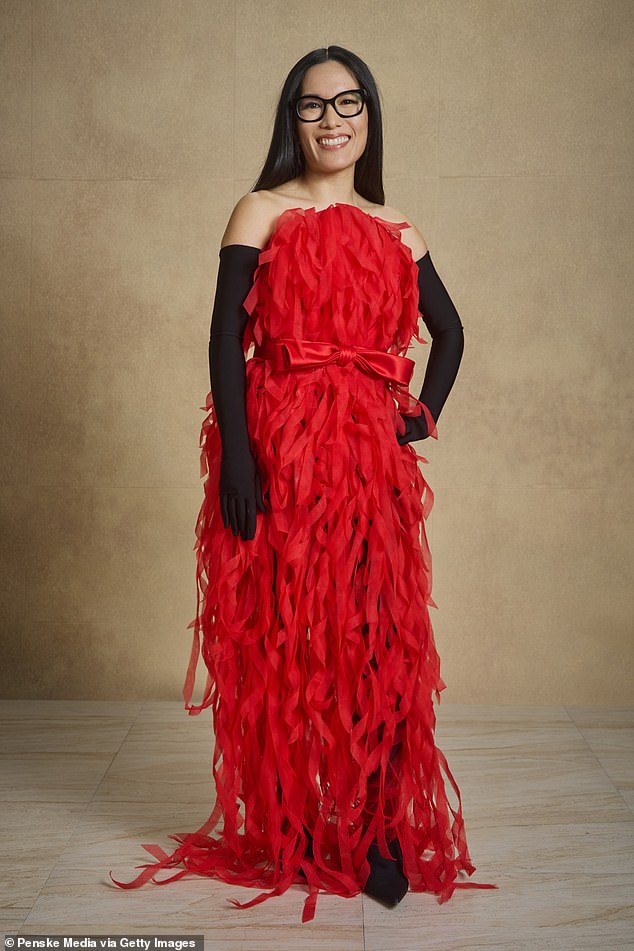 The 42-year-old funny woman wore a red, ripped Balenciaga dress with black opera-length gloves, selected by stylist Tara Swennen