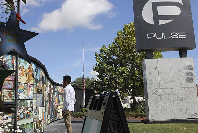 For many in the LGBTQ community, the Pulse shooting remains a terrifying reminder of their vulnerability. In this photo, Brandon Wolf, a survivor of the 2016 Pulse nightclub shooting and activist, looks at the photos that are part of the Pulse Memorial in Orlando, Florida