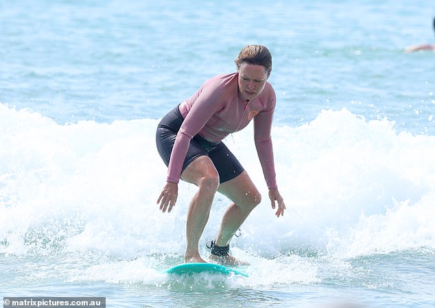 She tackled small waves as they rolled in, first finding her footing and trying to give it a try