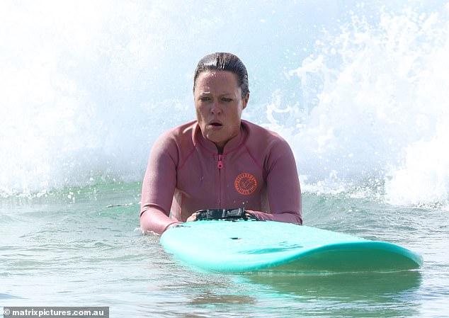 Angela looked sporty for her outing in figure-hugging surf wear and went make-up free for her surf session